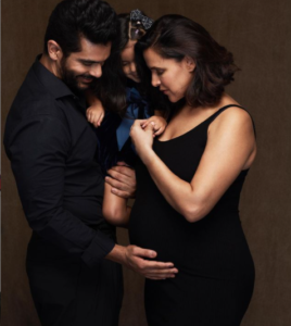 Neha shared a sweet picture of herself where she is seen flaunting her baby bump along with Angad and Mehr by her side.